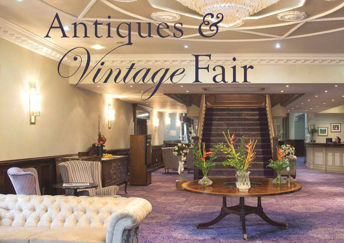 Image shows a warm and plush hotel interior, namely that of the Woodford Dolmen Hotel in Carlow, Ireland. Superimposed on the image is the text "Antiques & Vintage Fair" in reference to the events held there by vintageireland.eu